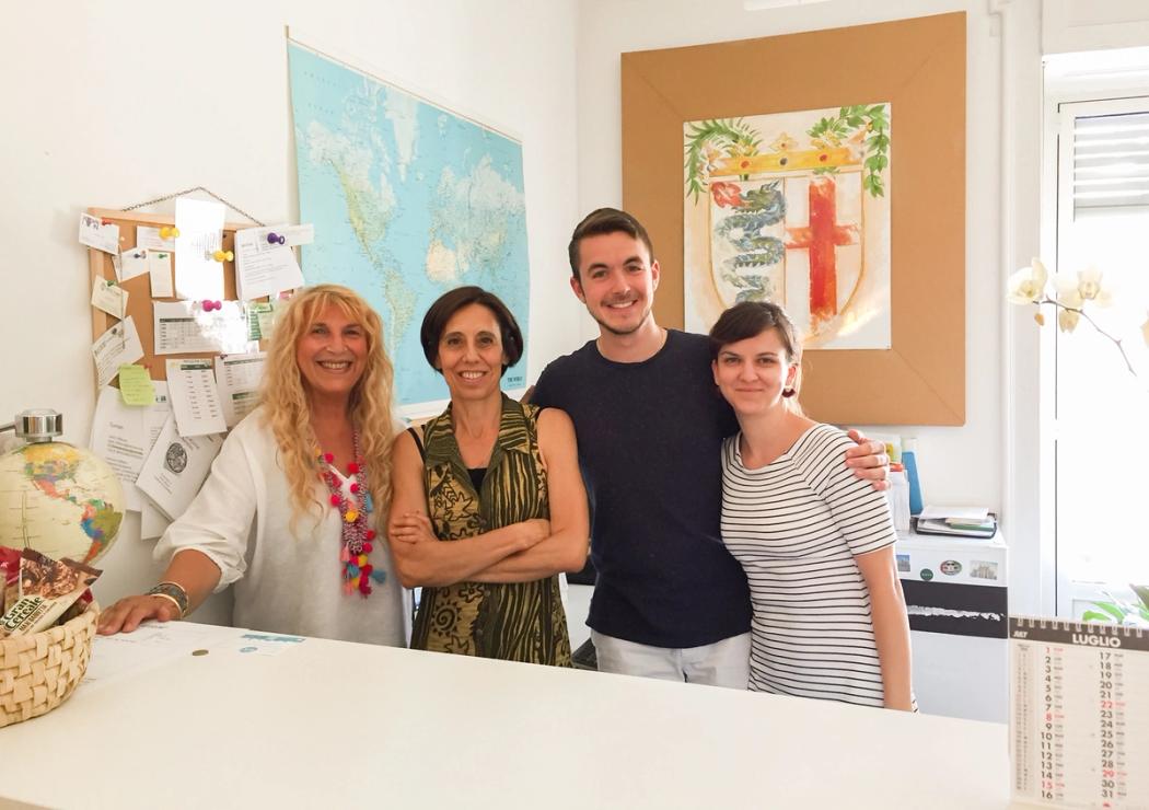 Rollins student stands with coworkers at his Italian internship.