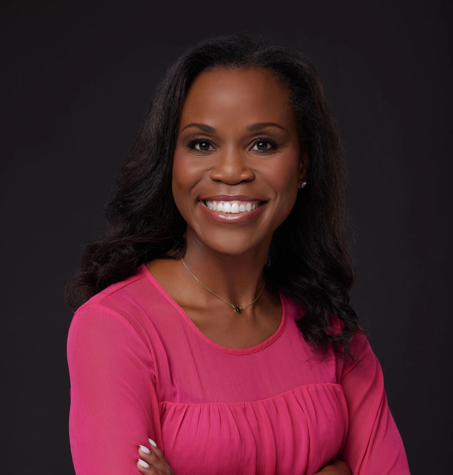 Headshot of Robiaun Charles smiling wearing bright pink blouse