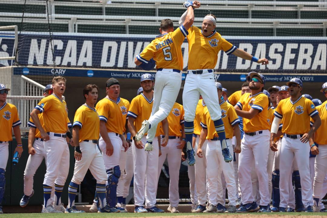 Rollins baseball team with two players leaping into a high-five.