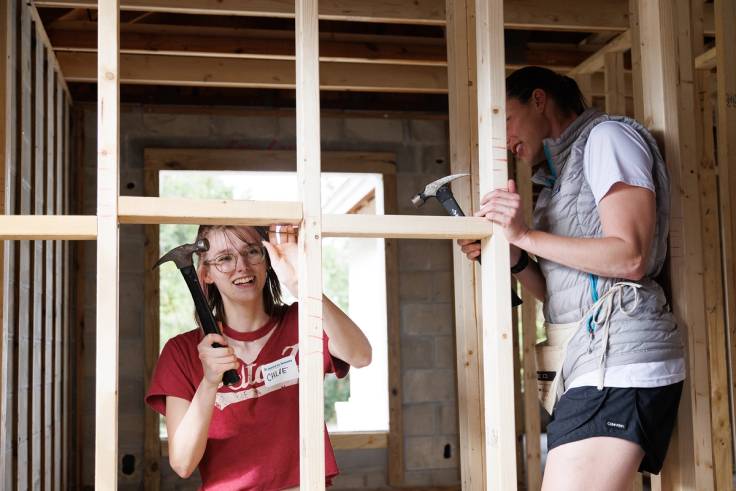 Students help build houses with Habitat for Humanity.