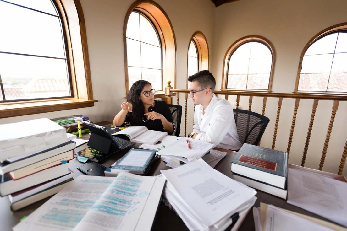 Josie Balzac-Arroyo works with her student on original research in the Olin Library.