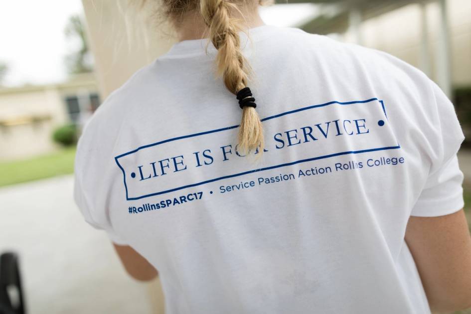 Rollins student volunteering during SPARC Day wears a shirt that says Life is for Service.