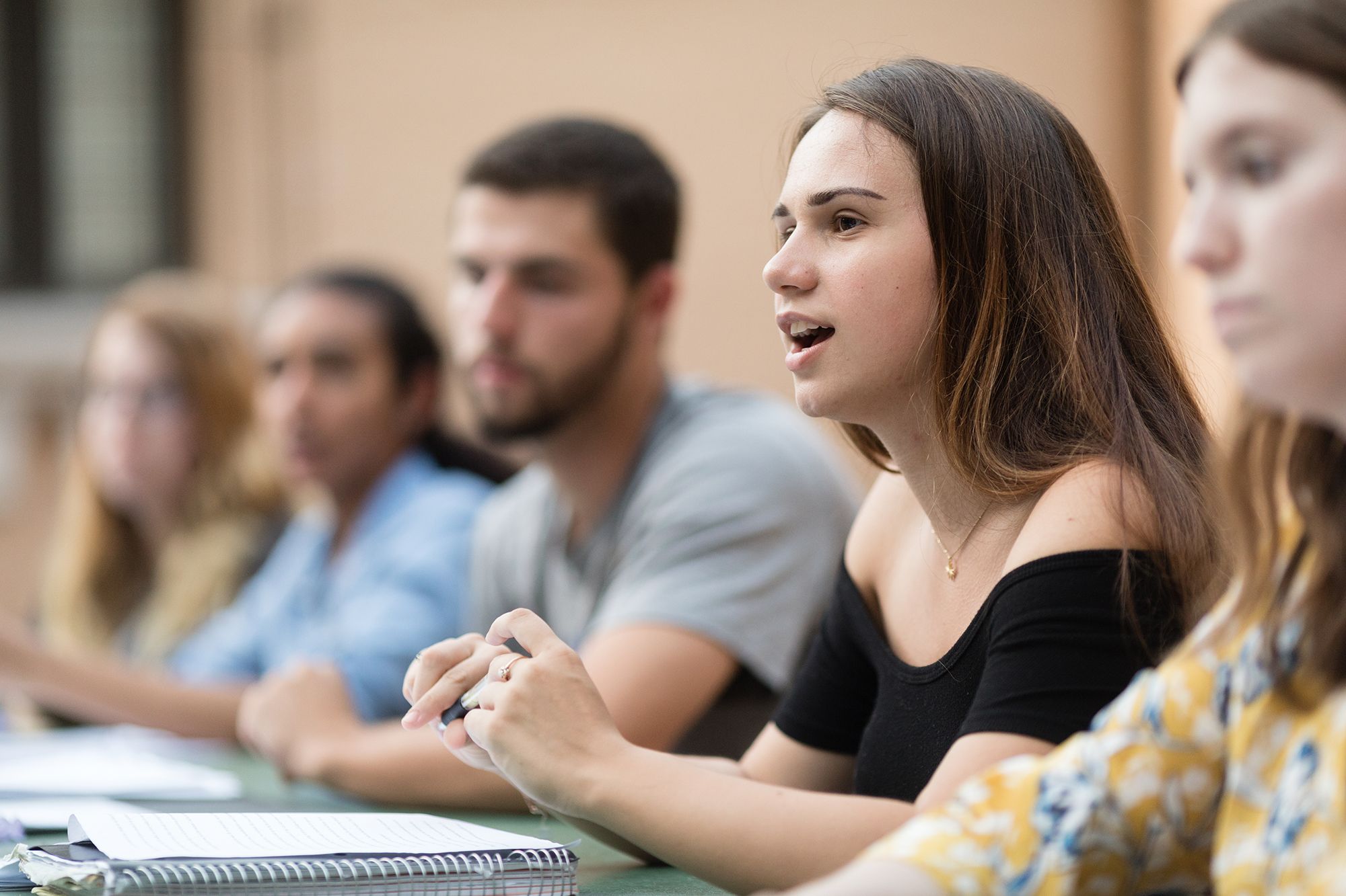 A student addresses her class in the outdoor classroom at Rollins. 