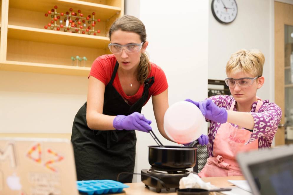 Two students cooking gelatin.