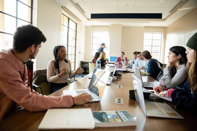 Students meeting in the Kathleen W. Rollins seminar room.