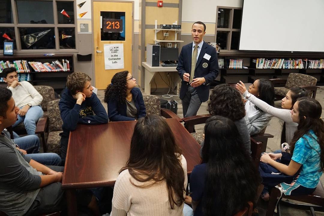 Rollins debate team member visits students at Lake Nona High School.