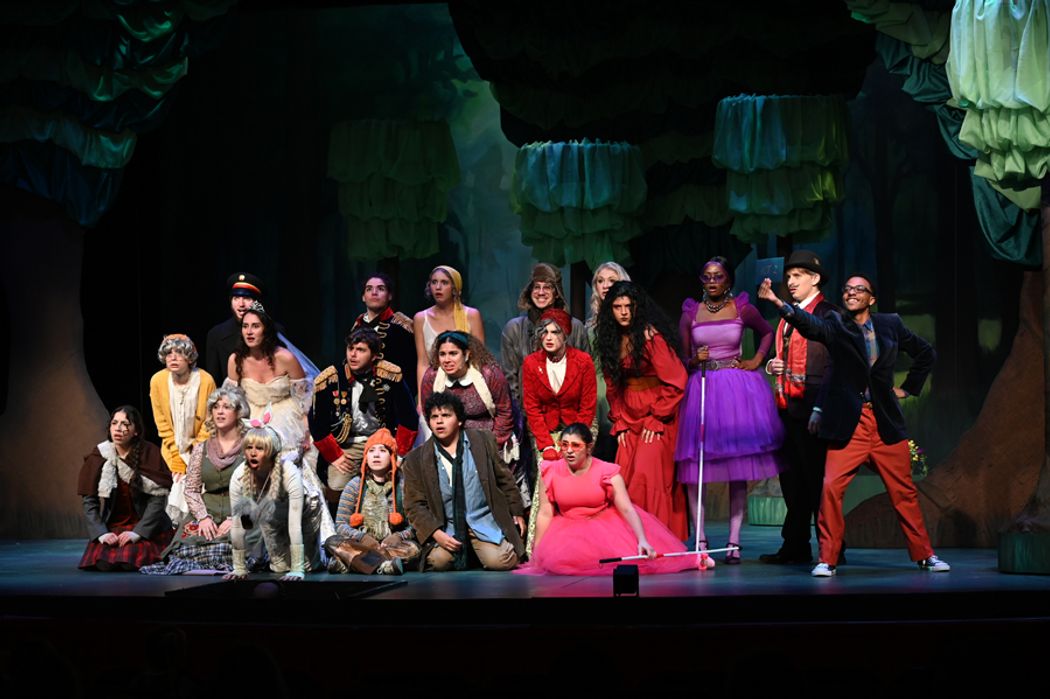 The cast Into the Woods huddled together with shocked faces.