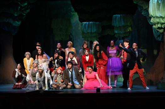 The cast Into the Woods huddled together with shocked faces.