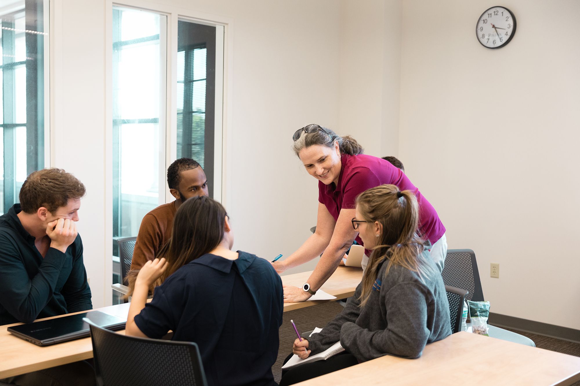 A professor explains a concept to a group of computer science students. 