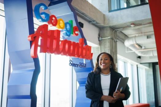 Tiffany Jones poses in front of the Google logo at the company's Atlanta offices.