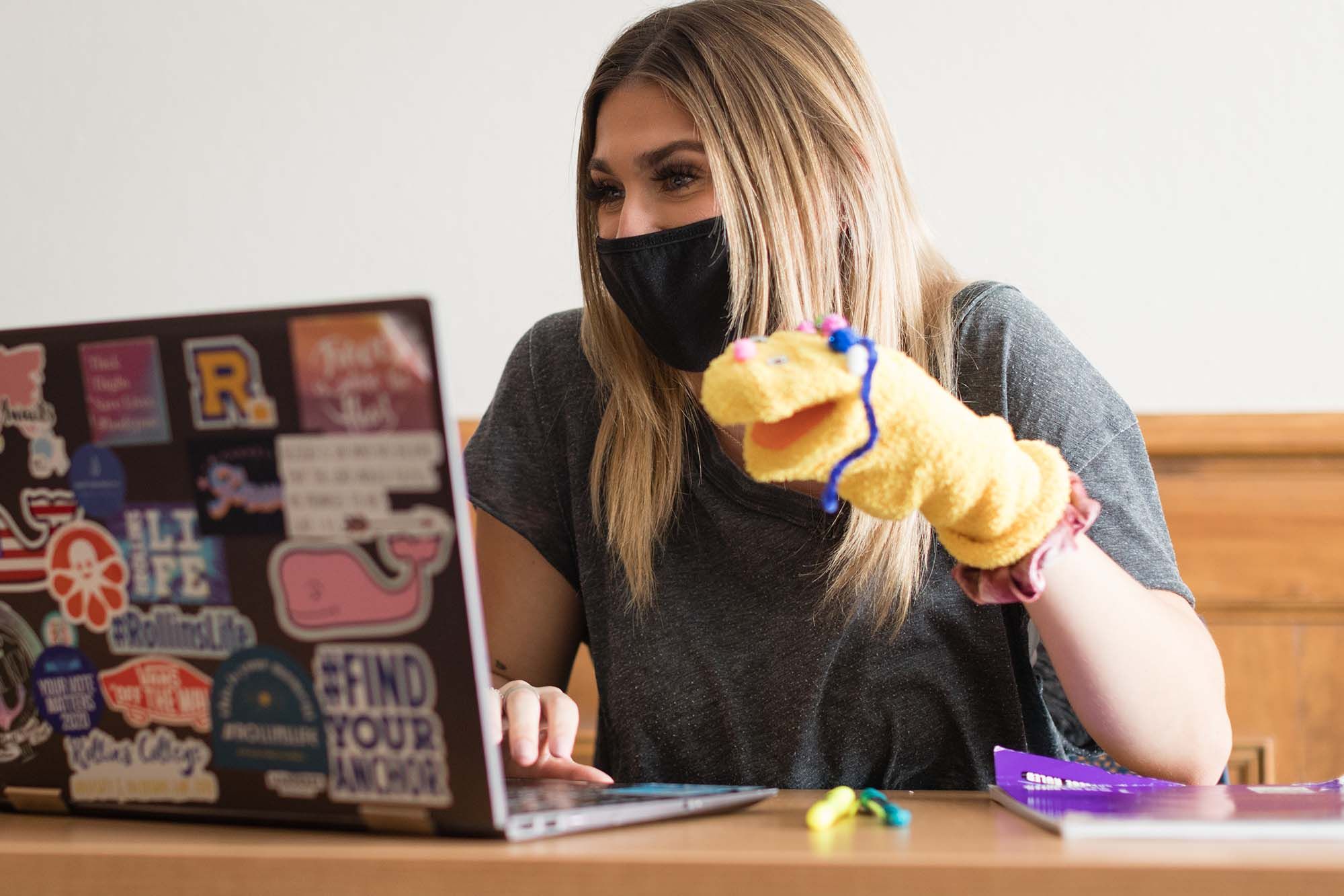 A student participates in a puppet workshop