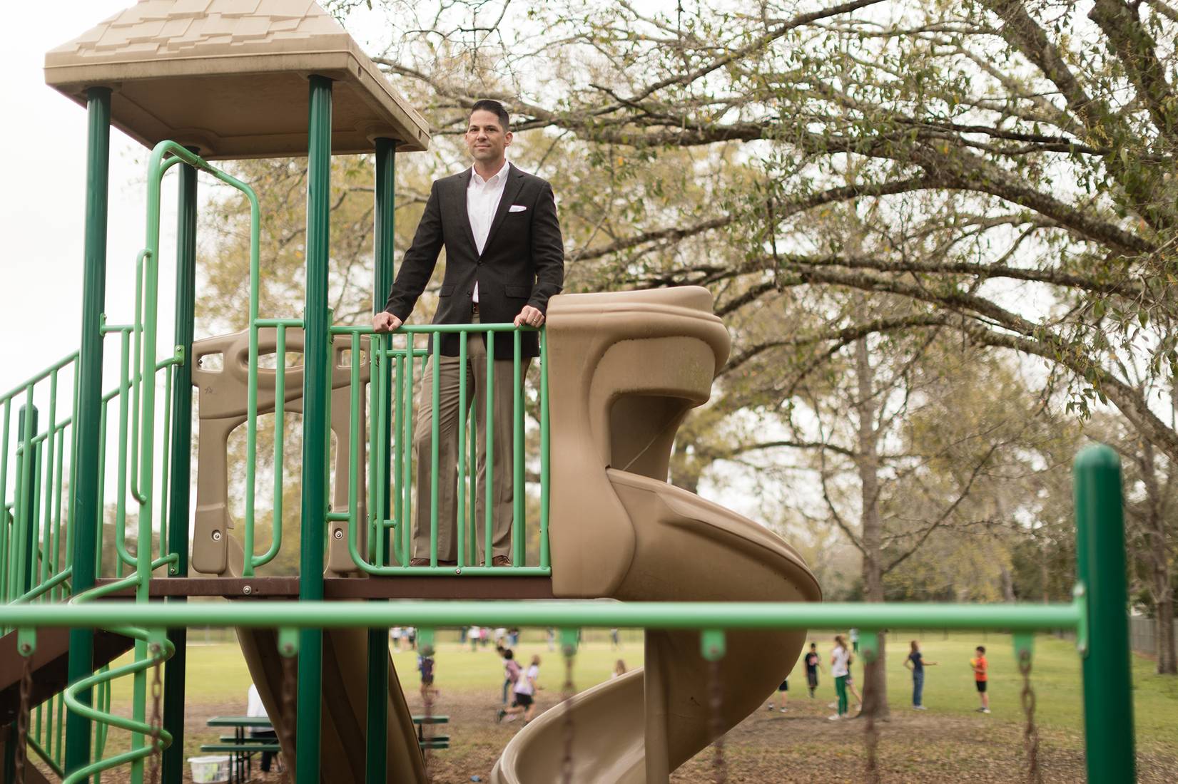 Neil Otto ’05 pictured on top of a playground near campus.