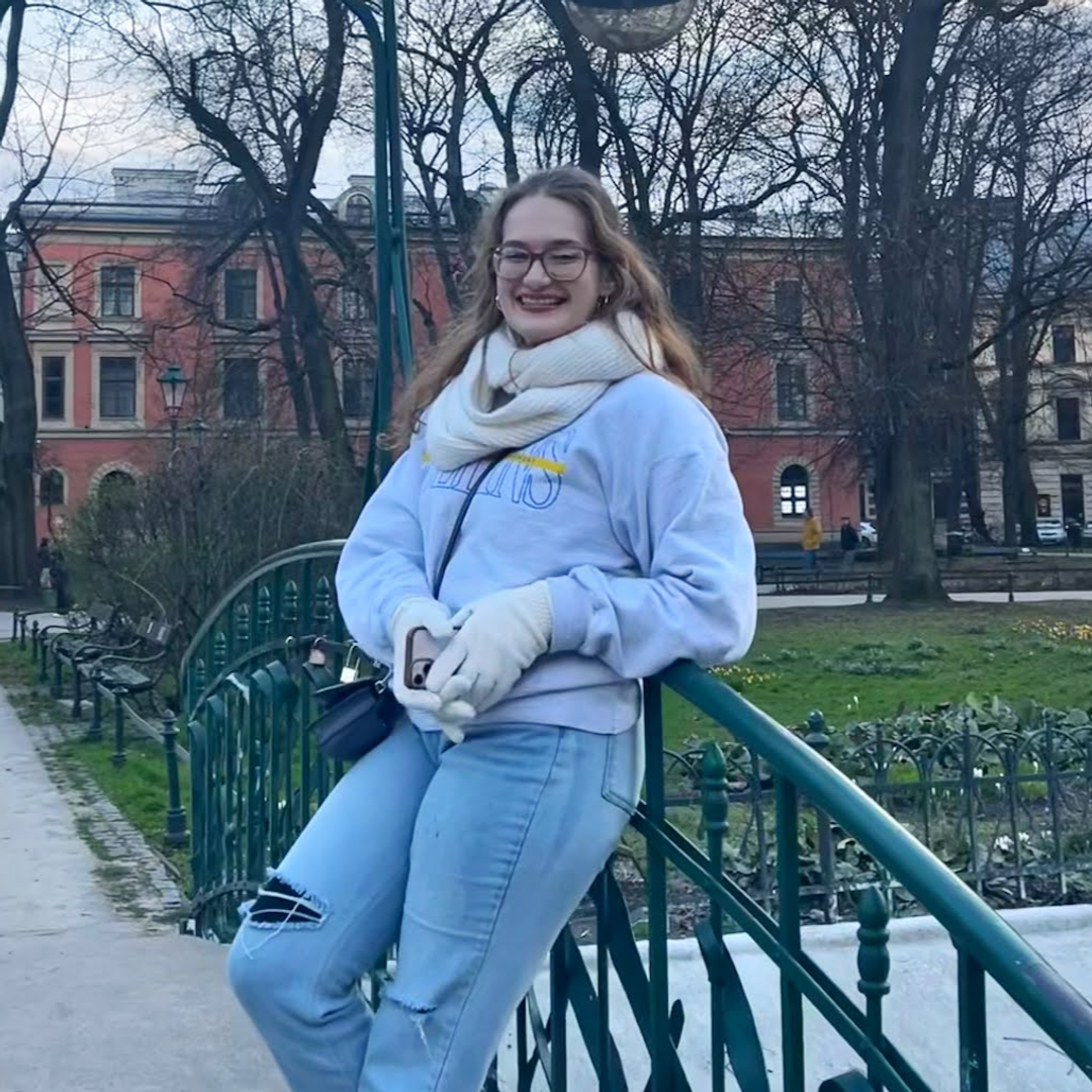 Rollins student, Angelina Davidson '25 poses on a bridge