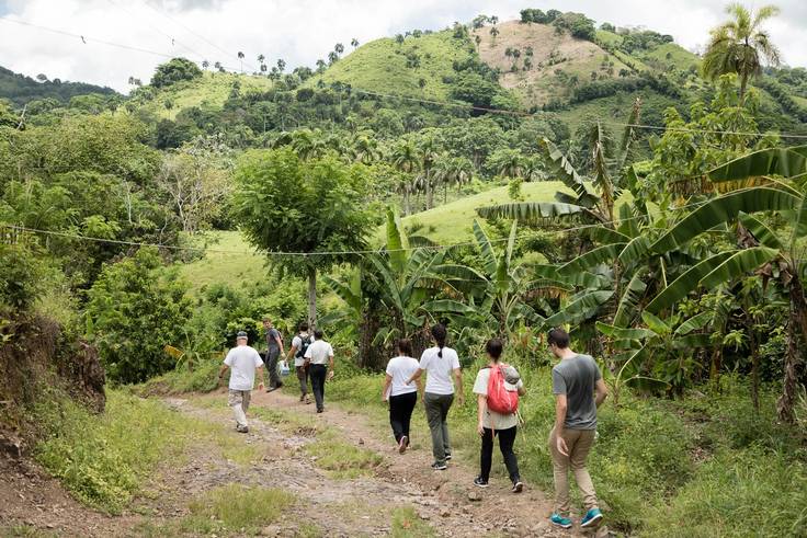 Students hike through the rural countryside in the Dominican Republic.
