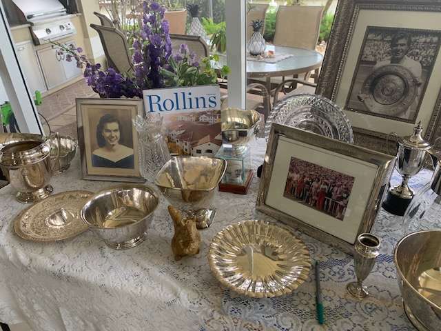 A table spread of photos and memorabilia from the life of tennis great Shirley Fry Irvin ’49 adorned with the most recent issue of Rollins magazine.