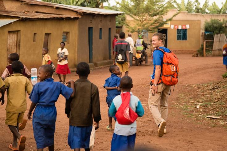 A Rollins students walks through the streets of Musha, Rwanda.