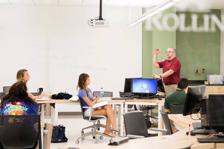 Physics professor Chris Fuse explains concepts in class.