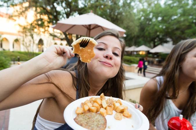 A student eats a pancake breakfast on Fox Day