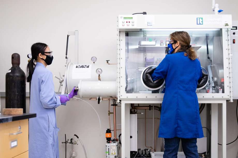 Chemistry student and professor collaborating on research in a lab.