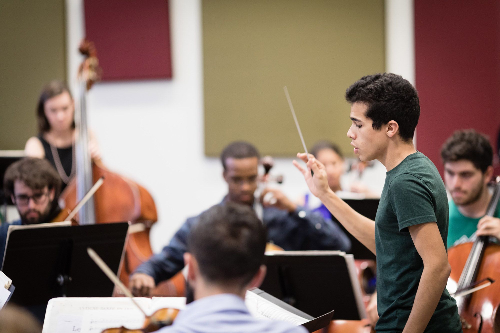 Music student conducting his fellow musicians.