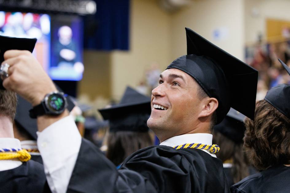 A student and the Rollins College fox fist bump.