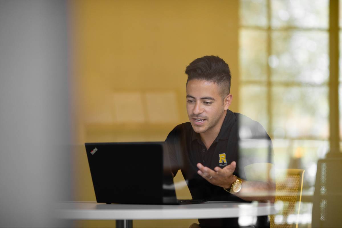 A Rollins College admission counselor video chats with a prospective student.