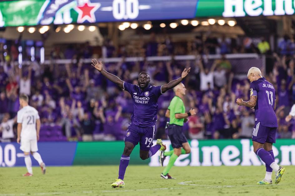 An Orlando City player celebrates scoring a goal.