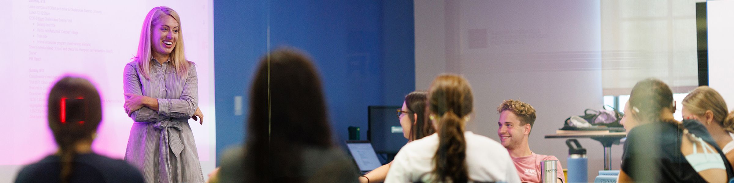 A professor engages a small group of students.