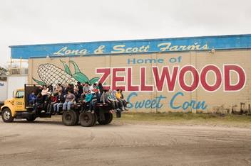 Students ride on a tractor at Zellwood Farm, not far from campus, where they work alongside migrant farmworkers. 