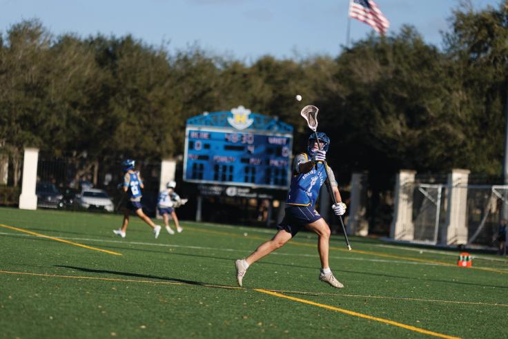 A lacrosse player catching the ball during a game