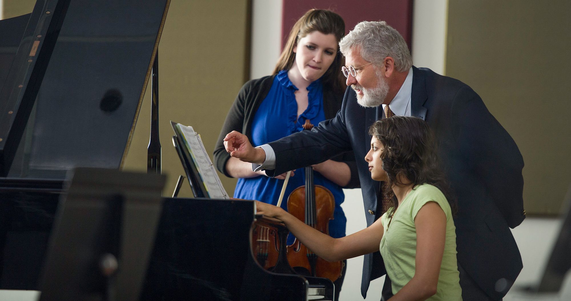 Rollins professor teaches students in piano and violin.