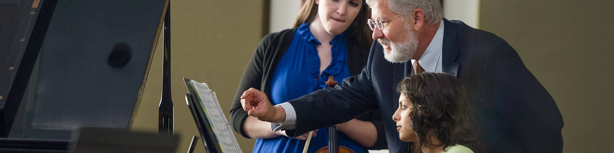 Rollins professor teaches students in piano and violin.