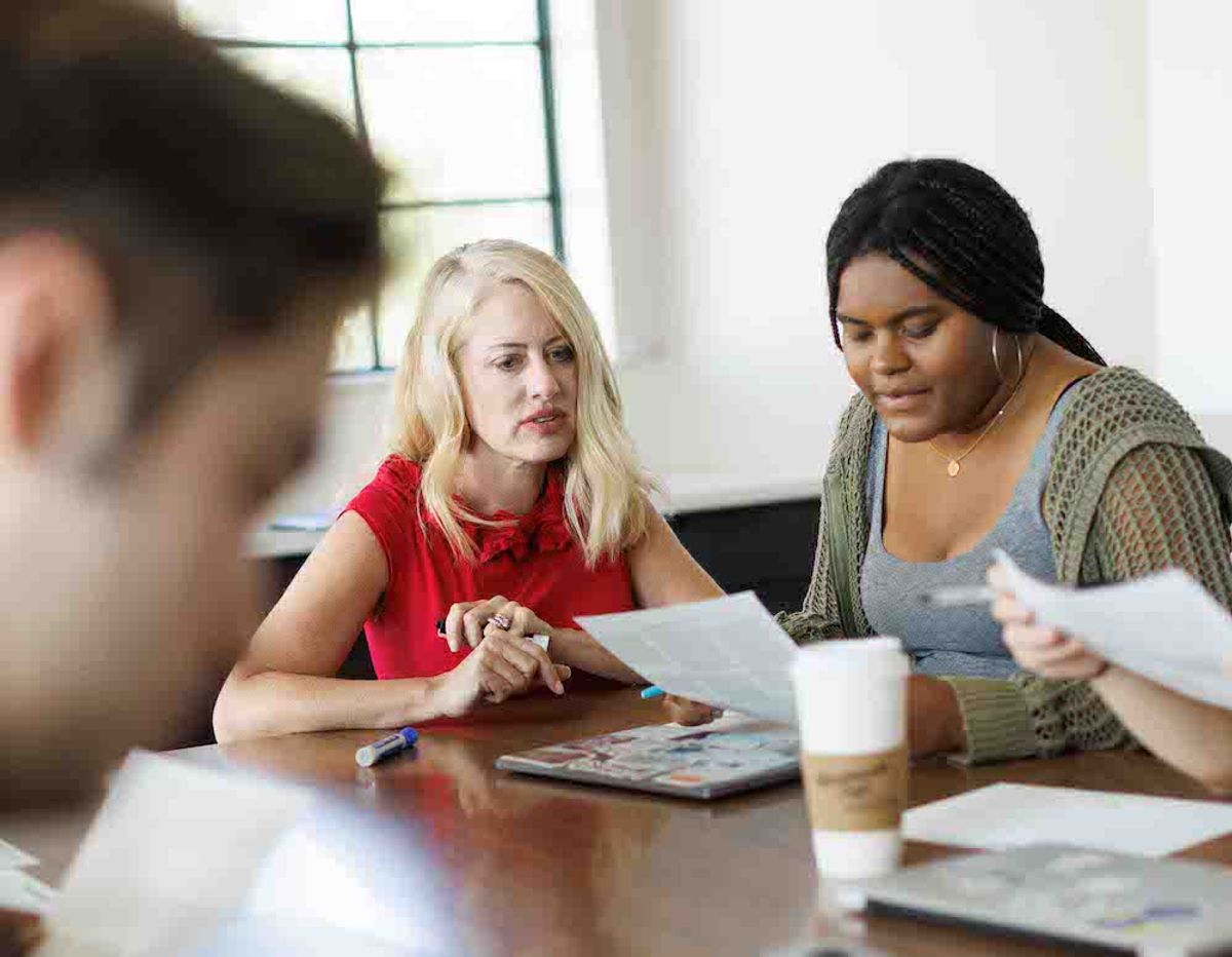 Jana Mathews engages in a group discussion with students in her class