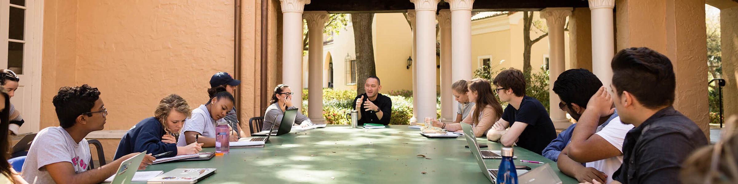 Rollins students attend a class in outdoor classroom.