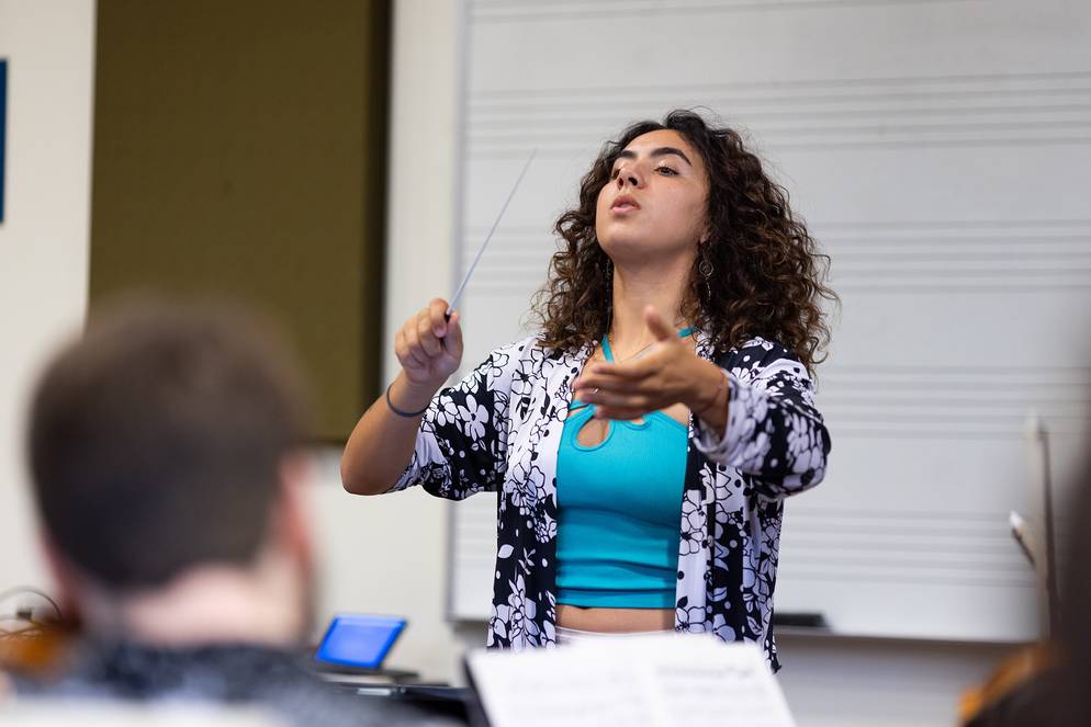 A student in a choral conducting class