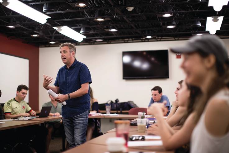 Spanish professor engages students in class discussion.