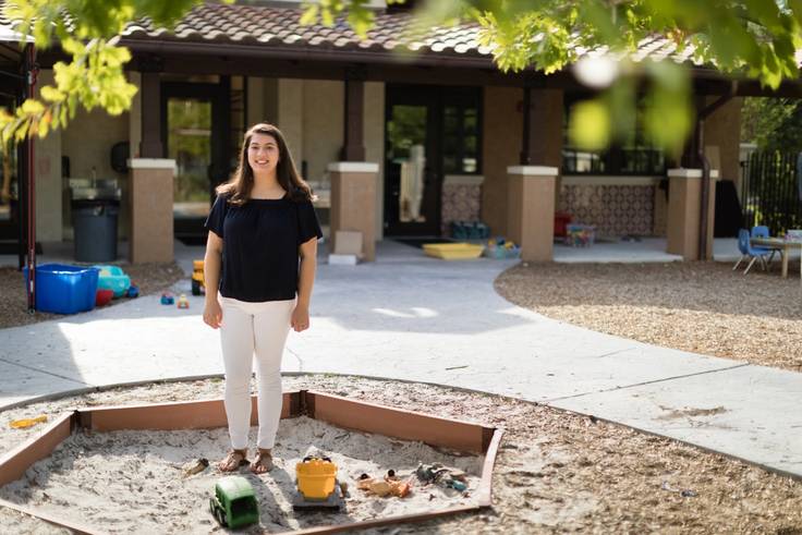 Alexandria Tomkunas ’18 sits on the edge of a sandbox