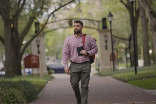 A commuter student walks to class at Rollins College.