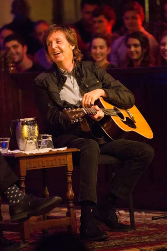 Sir Paul McCartney laughs during an interview with poet Billy Collins.