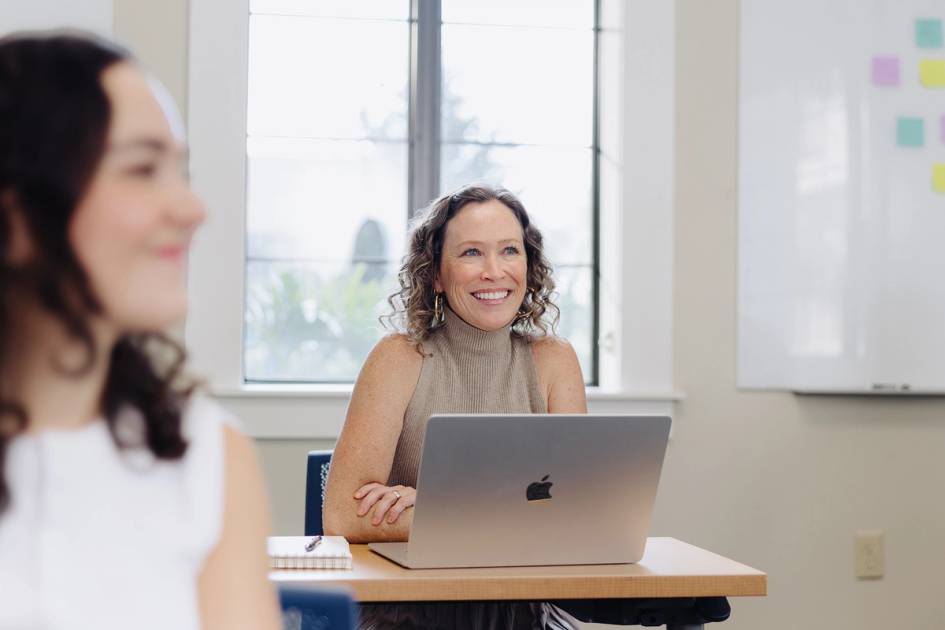 A counseling student smiles during class at Rollins College.