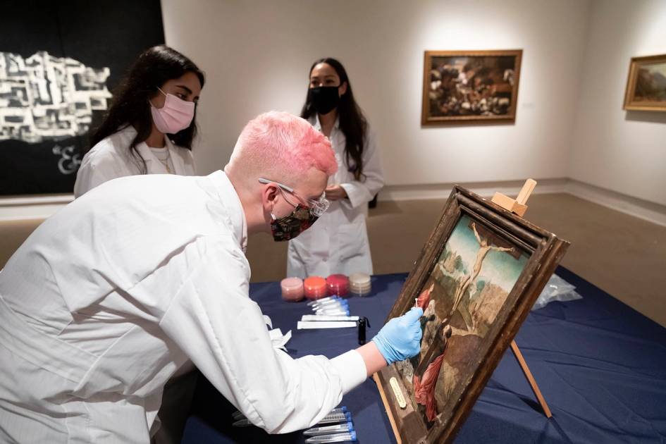 Rollins biology students take swabs off a Rollins Museum of Art piece to study.