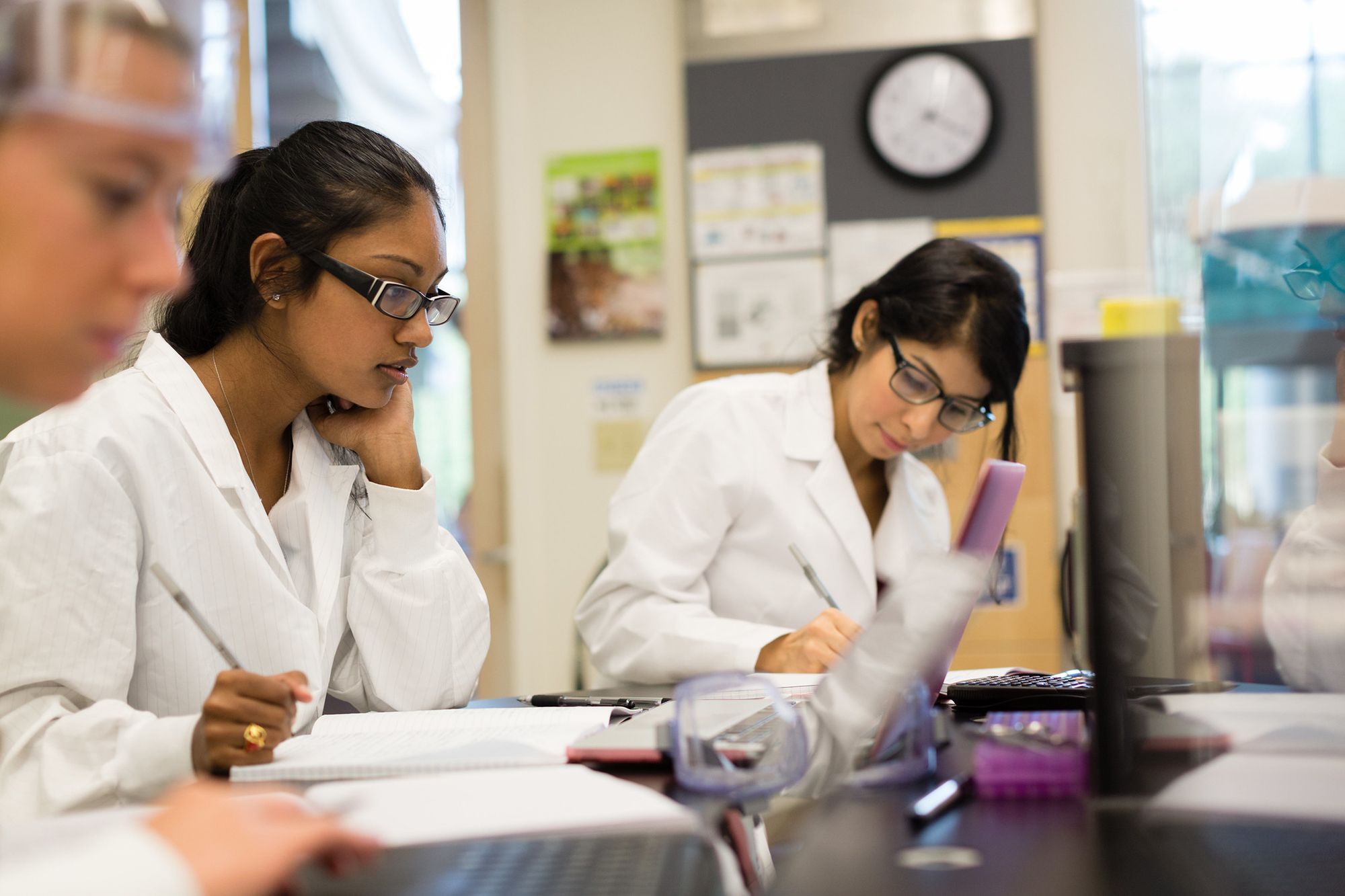 A students prepares a lab report.