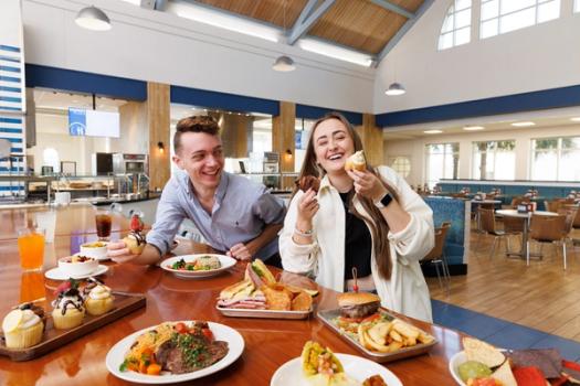 Two students have lunch together in the campus dining hall.