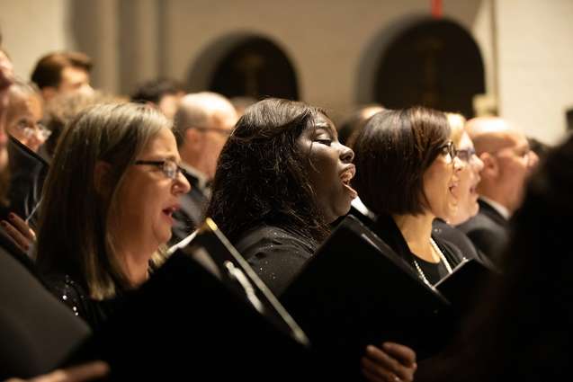 A choir singing during a performance at Knowles Chapel.
