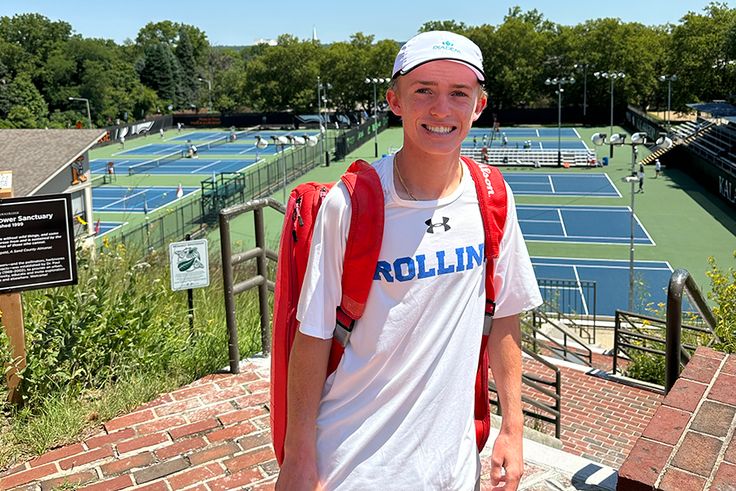 Lawson Prather in front of tennis courts in a Rollins T-shirt