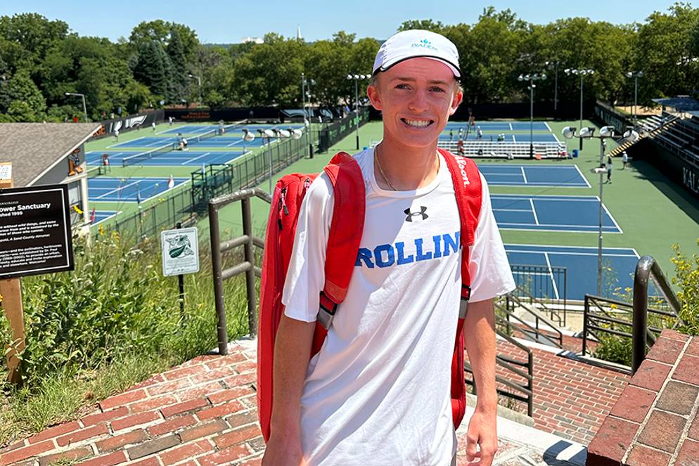 Lawson Prather in front of tennis courts in a Rollins T-shirt