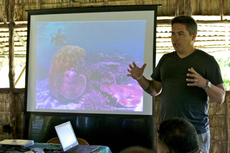 A communications director leads a meeting with a group of colleagues.