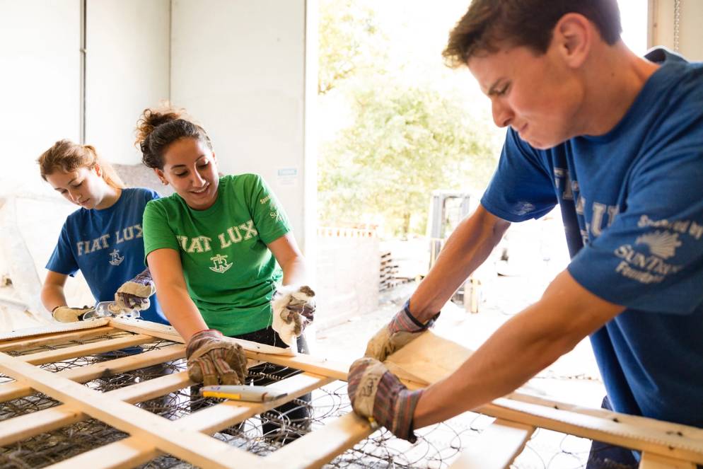 Students break down mattresses at a local nonprofit during SPARC Day, Rollins’ annual day of service.