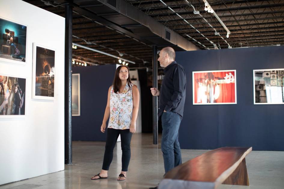 An intern reviews the collection at an Orlando art gallery.