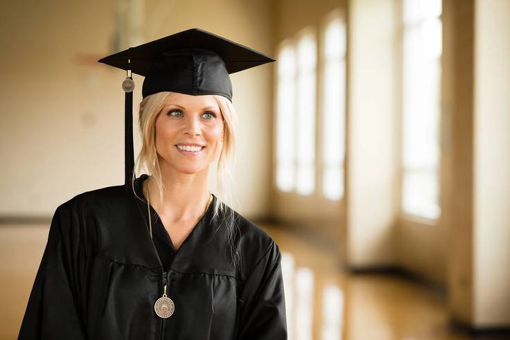 Elin Nordegren poses in her cap and gown in the Alfond Sports Center.